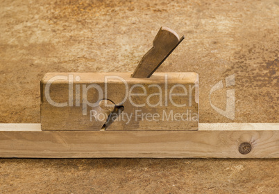 planer on wood in brown background