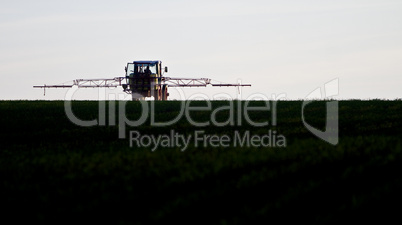 tractor spraying agricultural pesticide