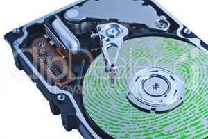 open hard drive with green fingerprint on platter