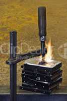 burning stack of hard drive pressed together with clamp