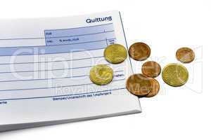 receipt with euro coins and ball-pen