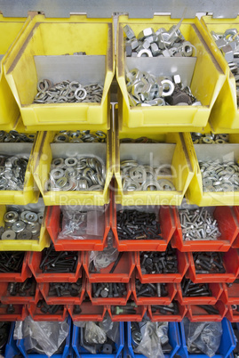 screws and nuts in colored boxes