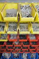 screws and nuts in colored boxes