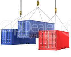 Three freight containers are being hoisted