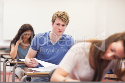 Handsome student writing an assignment