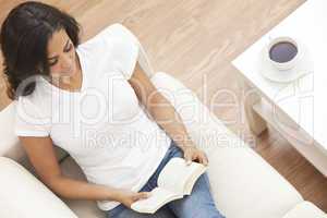 Hispanic Woman Reading Book Drinking Tea or Coffee