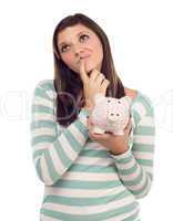 Ethnic Female Daydreaming and Holding Piggy Bank on White