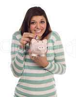 Ethnic Female Putting Coin Into Piggy Bank on White