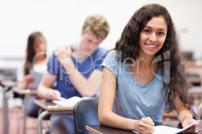 Smiling students working on an assignment