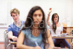 Student raising her hand to give an answer