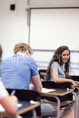 Portrait of a playful student sitting at a table