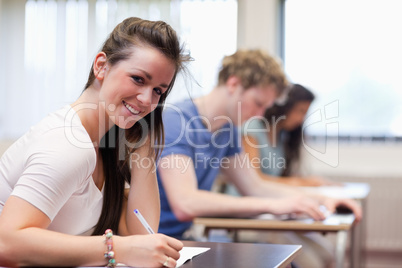 Smiling woman writing