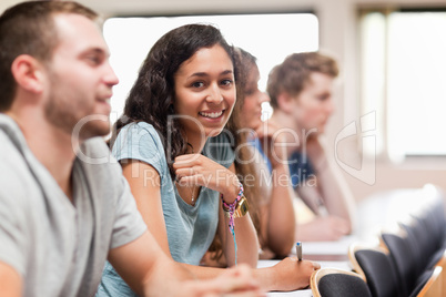 Smiling students listening a lecturer