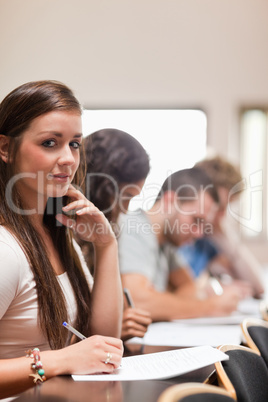 Portrait of good looking students listening a lecturer