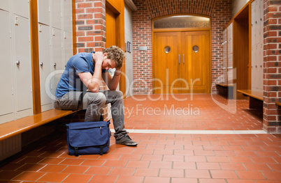 Sad student sitting on a bench