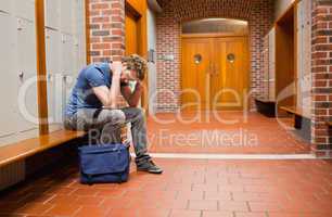 Sad student sitting on a bench