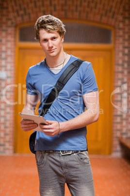 Portrait of a handsome student with a tablet computer