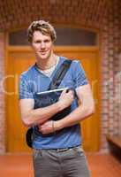 Portrait of a handsome student holding a book