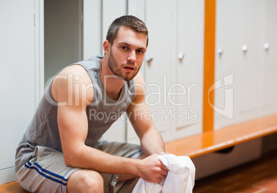 Young sports student sitting on a bench