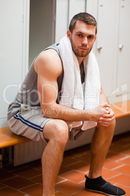 Portrait of a sports student sitting on a bench
