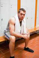 Portrait of a young sports student sitting on a bench