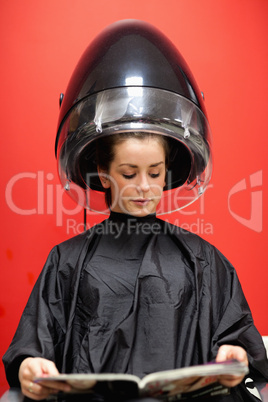 Portrait of a woman under a hairdressing machine
