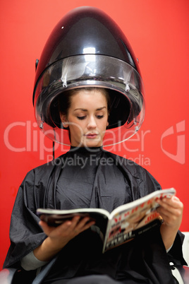 Portrait of a student under a hairdressing machine