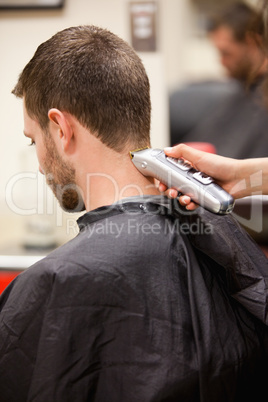 Portrait of man having a haircut