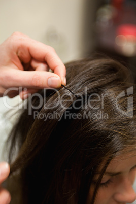 Portrait of a hairdresser putting a hairpin