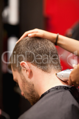 Portrait of a male young student having a haircut