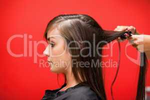 Woman having her hair straightened