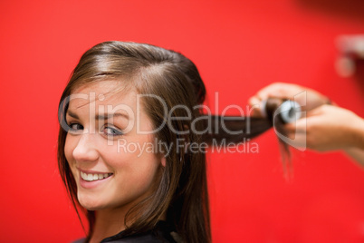Smiling woman having her hair rolled