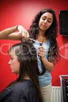 Portrait of a student hairdresser cutting hair