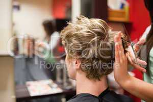 Blond-haired man having a haircut
