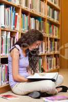 Portrait of a female student reading a book