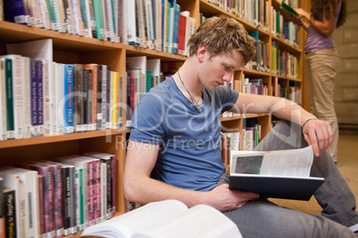 Male student reading a book