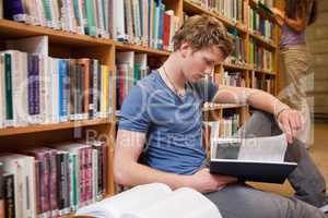 Male student reading a book