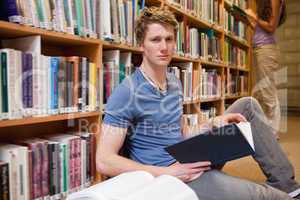 Male student holding a book