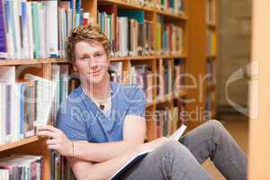 Handsome student picking a book