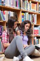 Portrait of female students reading a book