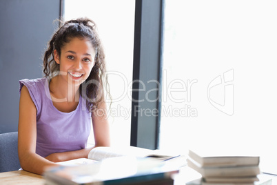 Smiling student sitting with a book