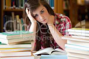 Depressed student surrounded by books