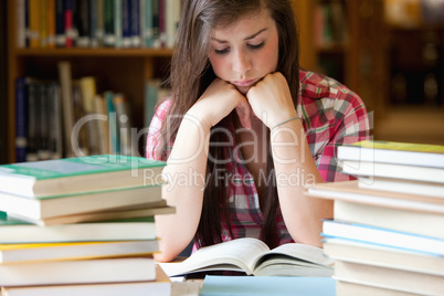 Studious woman surrounded by books