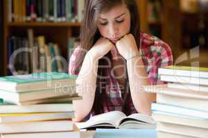 Studious woman surrounded by books