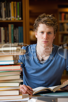 Portrait of a male student posing with books