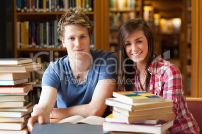 Smiling students surrounded by books