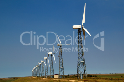 The wind generators against the blue sky