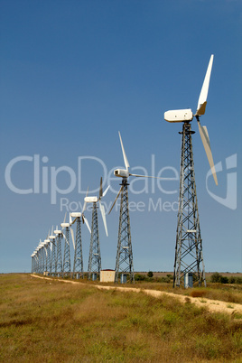 The wind generators against the blue sky