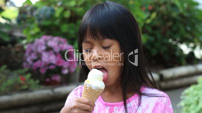 Little Asian Girl Eating Ice Cream Cone