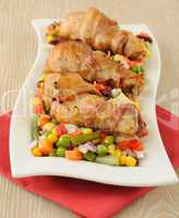 chicken leg wrapped in bacon with vegetables